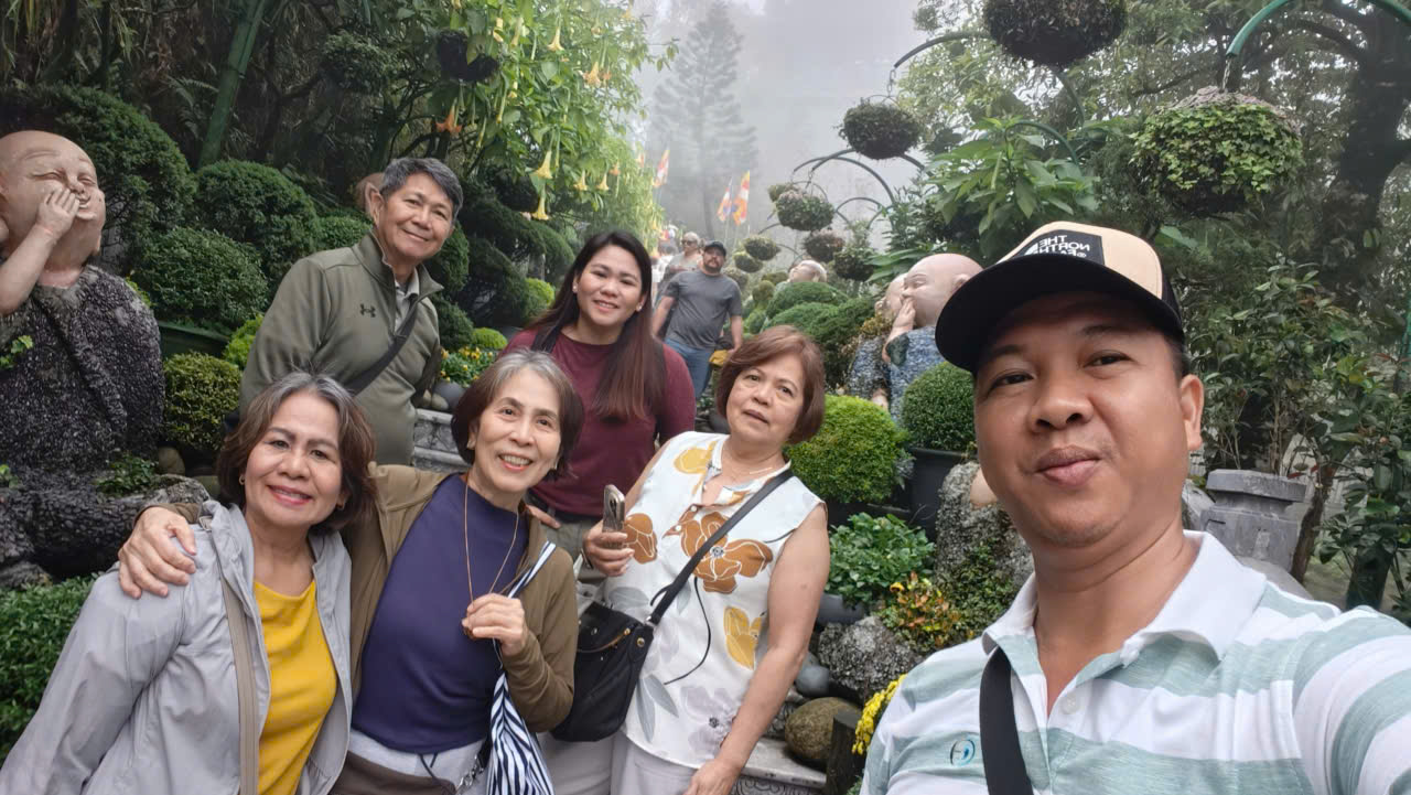 Viet Nguyen takes a selfie with guests on the way to Linh Phong Thien Tu Pagoda at Ba Na Hills