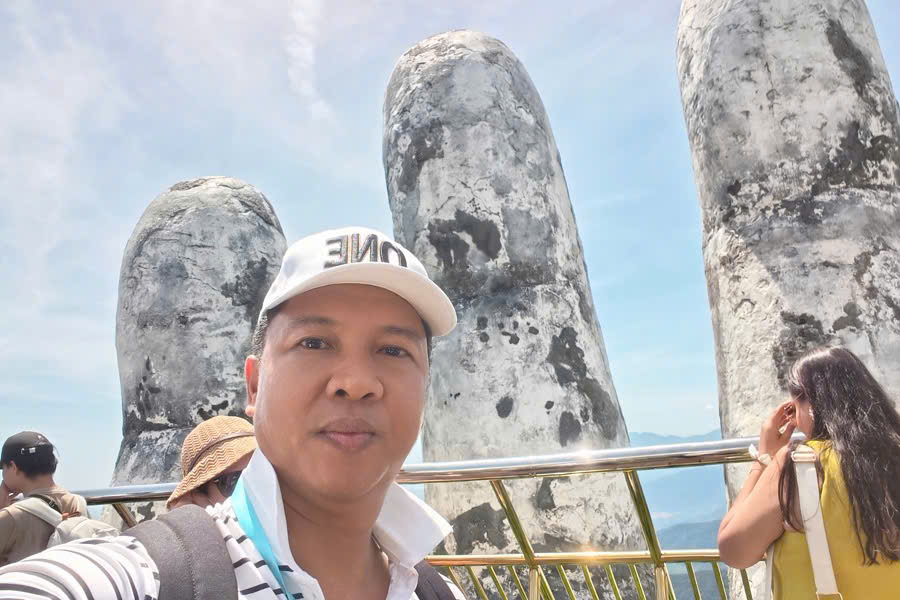 Viet Nguyen, Founder and CEO of Premium Travel Vietnam, taking a selfie at the Golden Bridge in Ba Na Hills.