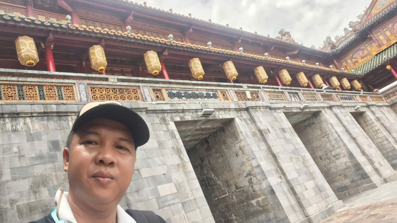 Viet Nguyen standing at Ngo Mon Gate, the main entrance to the Hue Imperial City in Vietnam.