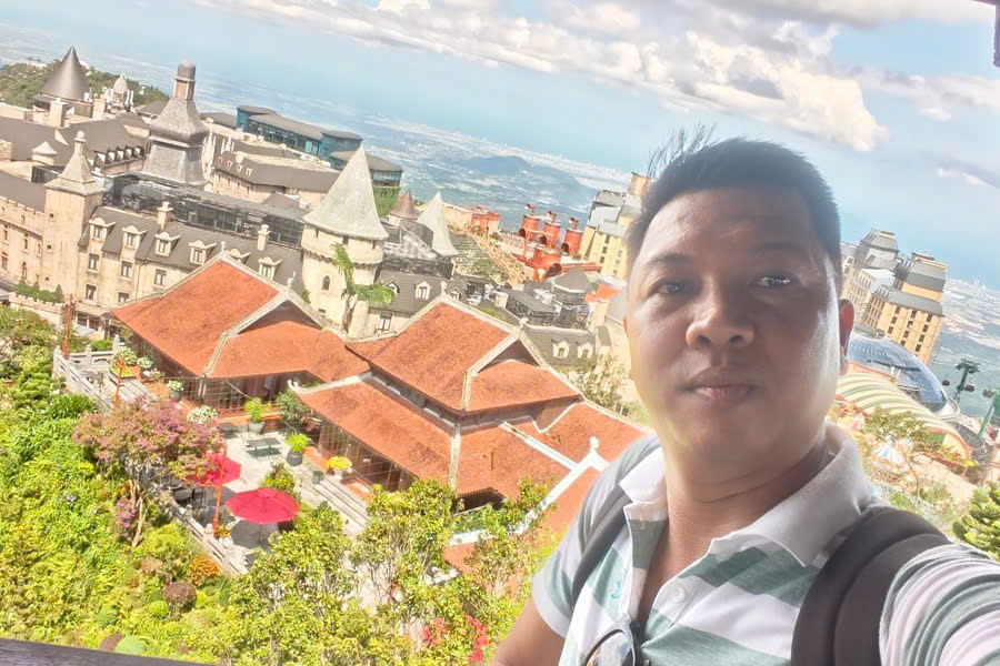 Viet Nguyen takes a selfie with Ba Na Hills and Da Nang in the distance