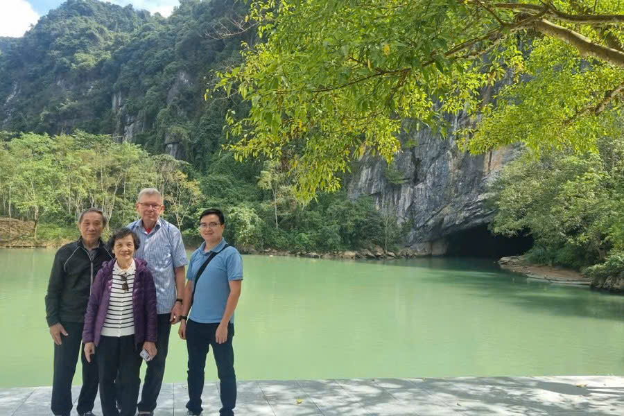 Guests taking photos at the entrance of Phong Nha Cave during a private Phong Nha Cave and Paradise Cave tour in Vietnam.