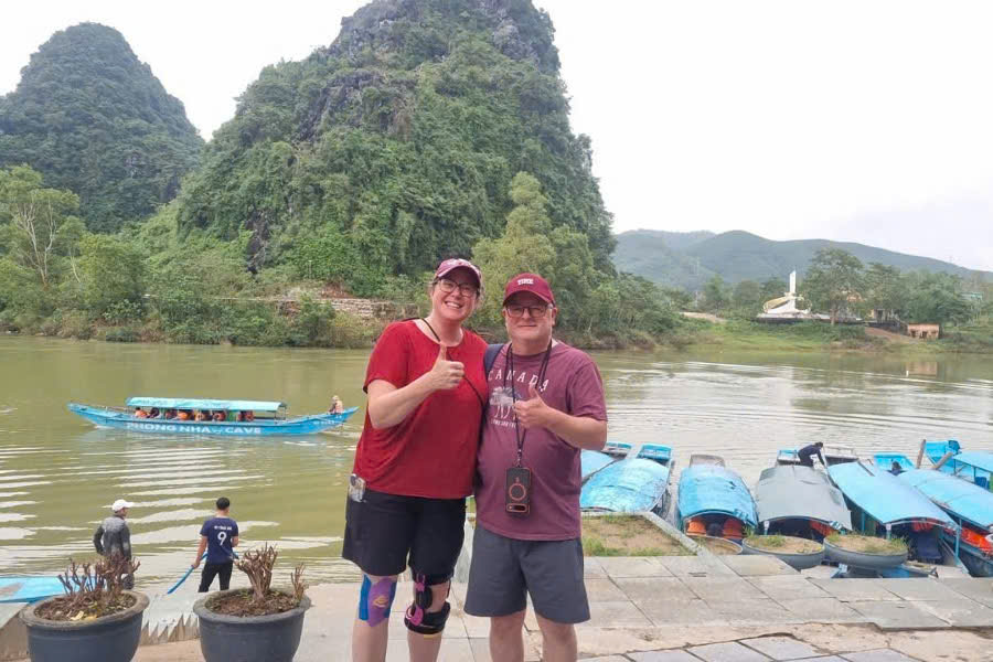 Guests taking photos at the Son River dock during a Phong Nha National Park tour in Quang Binh, Vietnam.