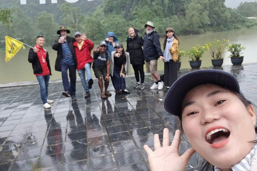 Premium Travel Vietnam tour guide taking a selfie with guests by the Son River during a Phong Nha National Park tour.