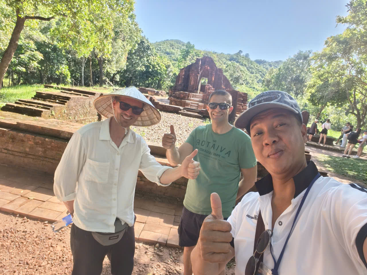 Viet Nguyen taking a selfie with guests at Group G temples during a private guided My Son Sanctuary tour from Hoi An hotel