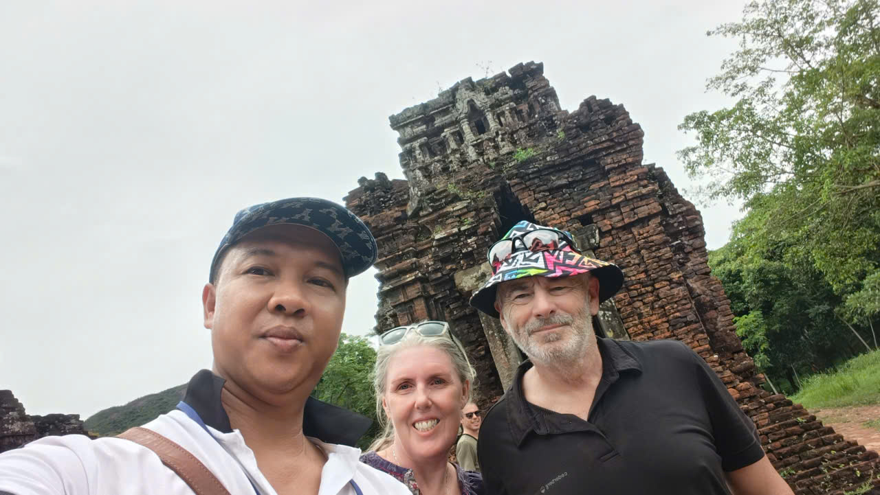 Viet Nguyen taking a photo with guests during a private My Son Sanctuary tour in Da Nang at ancient Cham temple ruins