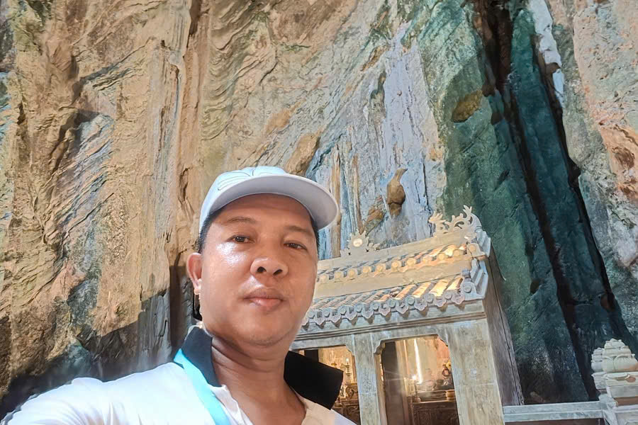Viet Nguyen taking a photo inside Huyen Khong Cave at Marble Mountains during a Hoi An day trip from Da Nang.