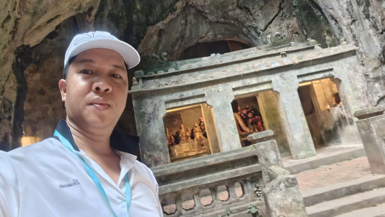 Viet Nguyen takes a selfie in front of a temple inside Huyen Khong Cave at Marble Mountains