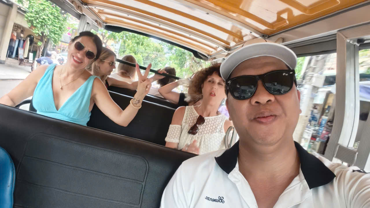 Tour guide taking a selfie with guests on a buggy ride at My Son Sanctuary