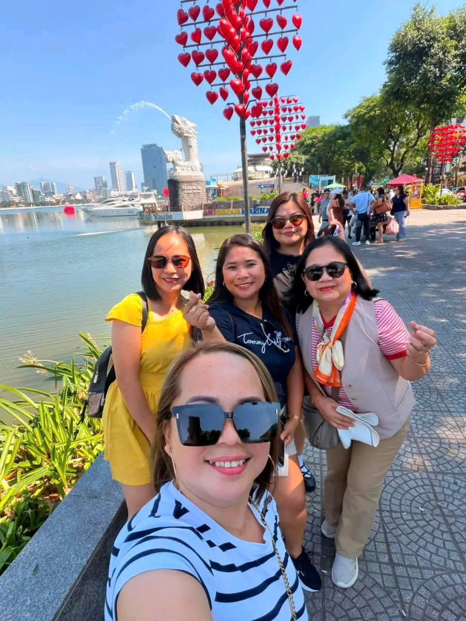 Guests posing for photos with the Koi Carp Dragon Statue along the Han River in Da Nang, Vietnam.