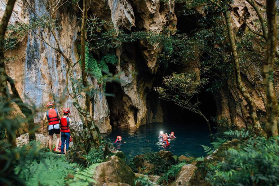Tourists swimming inside Dark Cave in Phong Nha