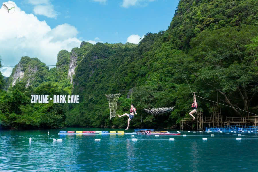 Tourists ziplining across the Chay River toward Dark Cave in Phong Nha