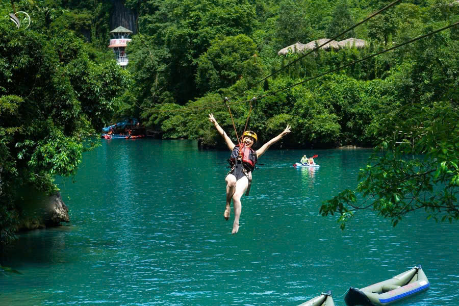Tourist ziplining across the Chay River in Phong Nha
