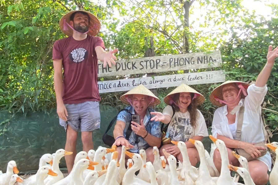 Tourists taking photos with ducks at Duck Stop Phong Nha