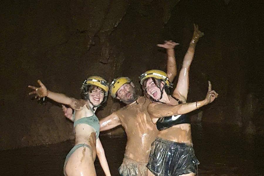 Guests enjoying a mud bath inside Dark Cave in Phong Nha