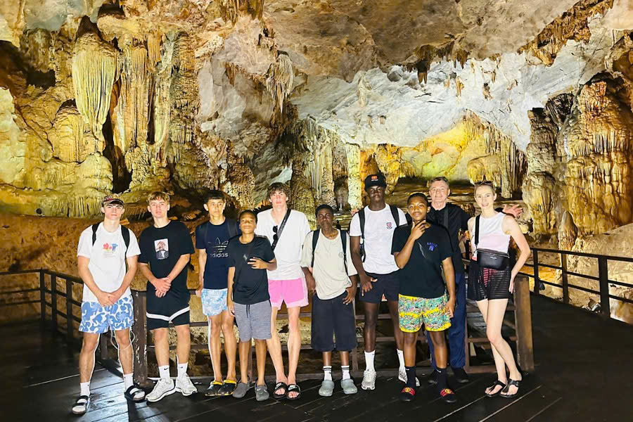Group of travelers exploring Phong Nha Cave during a boat trip in Vietnam