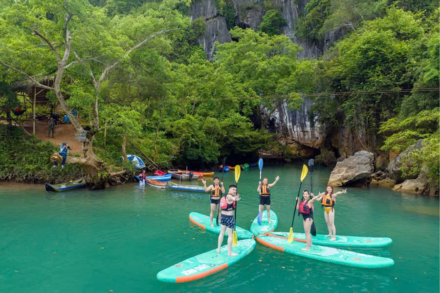 Tourists enjoying a boat tour on the Son River to Phong Nha Cave