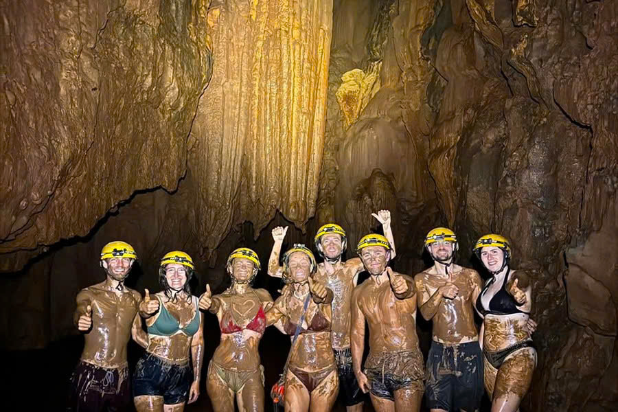 Tourists enjoying a mud bath inside Dark Cave in Phong Nha.