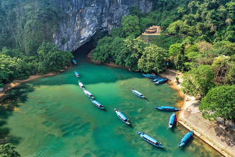 Boats carrying tourists into the entrance of Phong Nha Cave