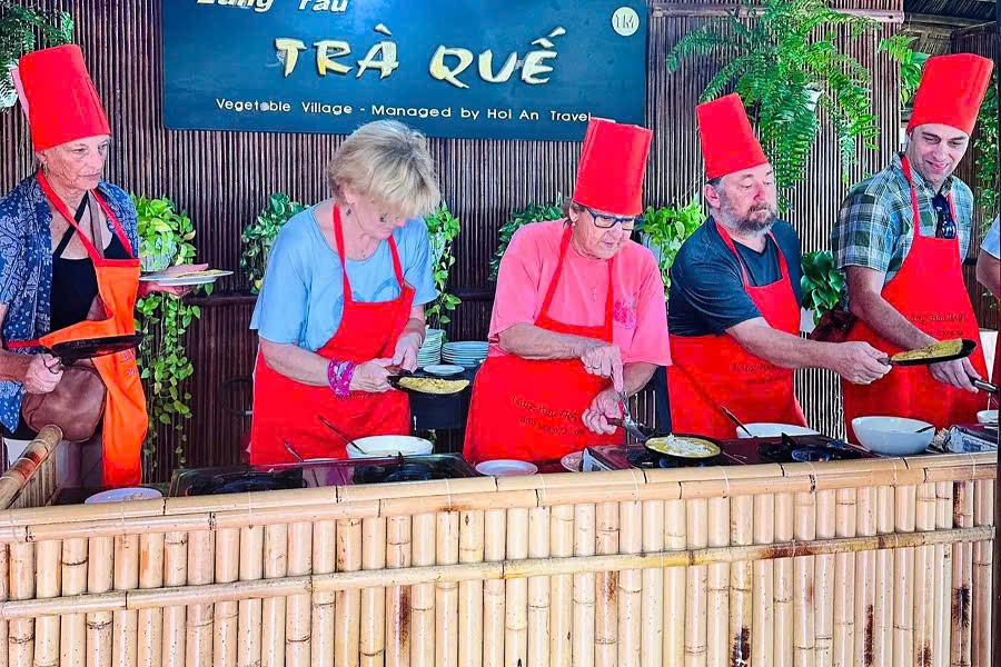 Guests learning how to make Banh Xeo at Tra Que Village, Hoi An