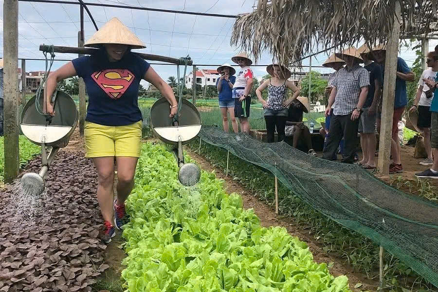 Guest learning traditional vegetable farming at Tra Que Village, Hoi An
