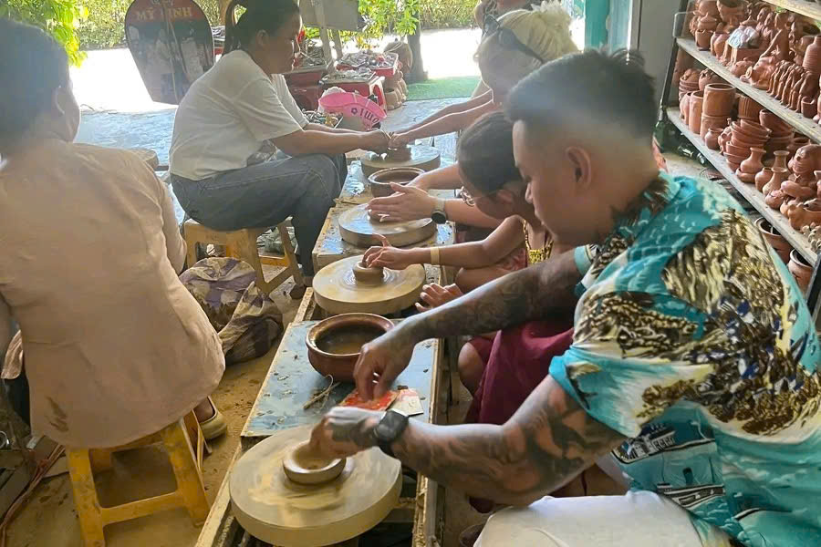 Tourists learning traditional pottery making in Thanh Ha Village, Hoi An