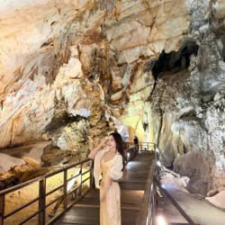 Tourist taking a selfie inside Thien Duong Cave in Phong Nha
